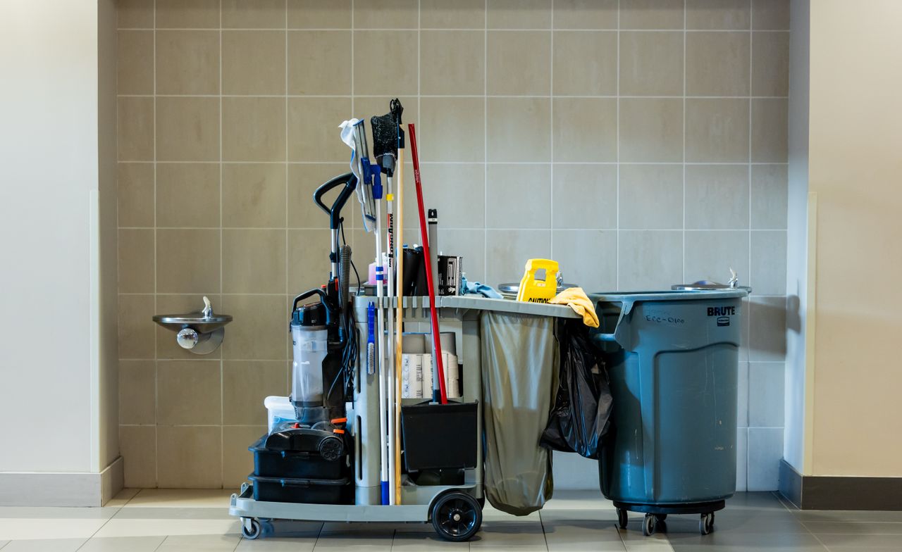 gallery-1 A comprehensive collection of professional cleaning tools on a cart in an indoor environment.